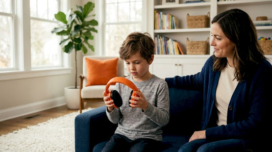 Boy exploring earmuffs with supportive parent