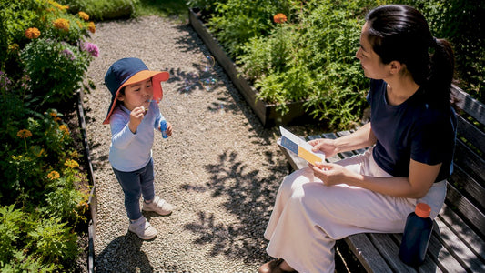 Mother supervising child with UPF sun gear outdoors